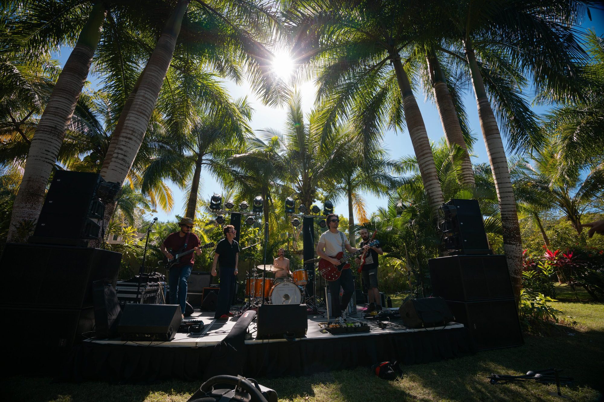 Band performing under pink lights