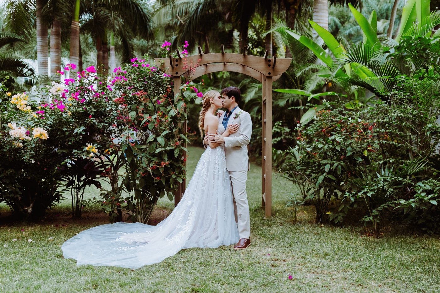 Couple kissing under garden arch